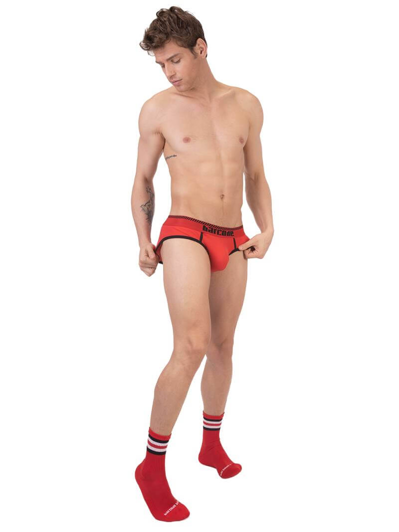 A man wearing a blue Barcode Berlin brief with white trims and a brand logo on the waistband.