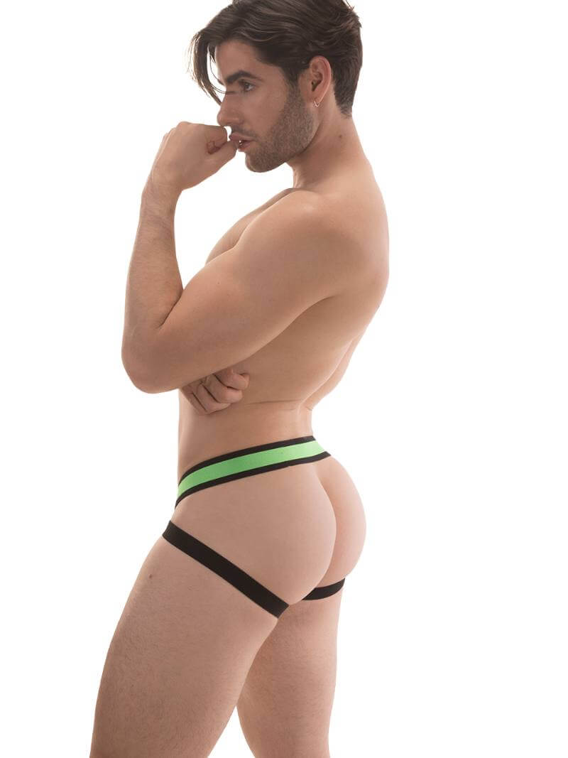 A model wearing a neon green jockstrap with black straps and a striped waistband with the Barcode Berlin brand label.