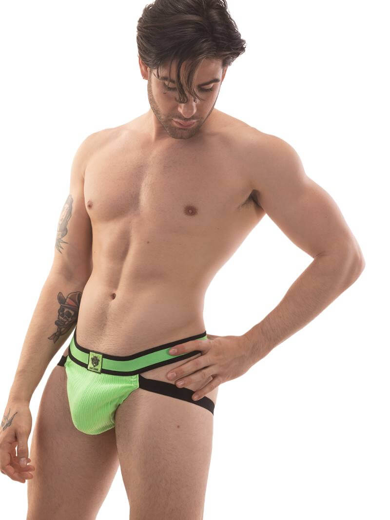 A model wearing a neon green jockstrap with black straps and a striped waistband with the Barcode Berlin brand label.