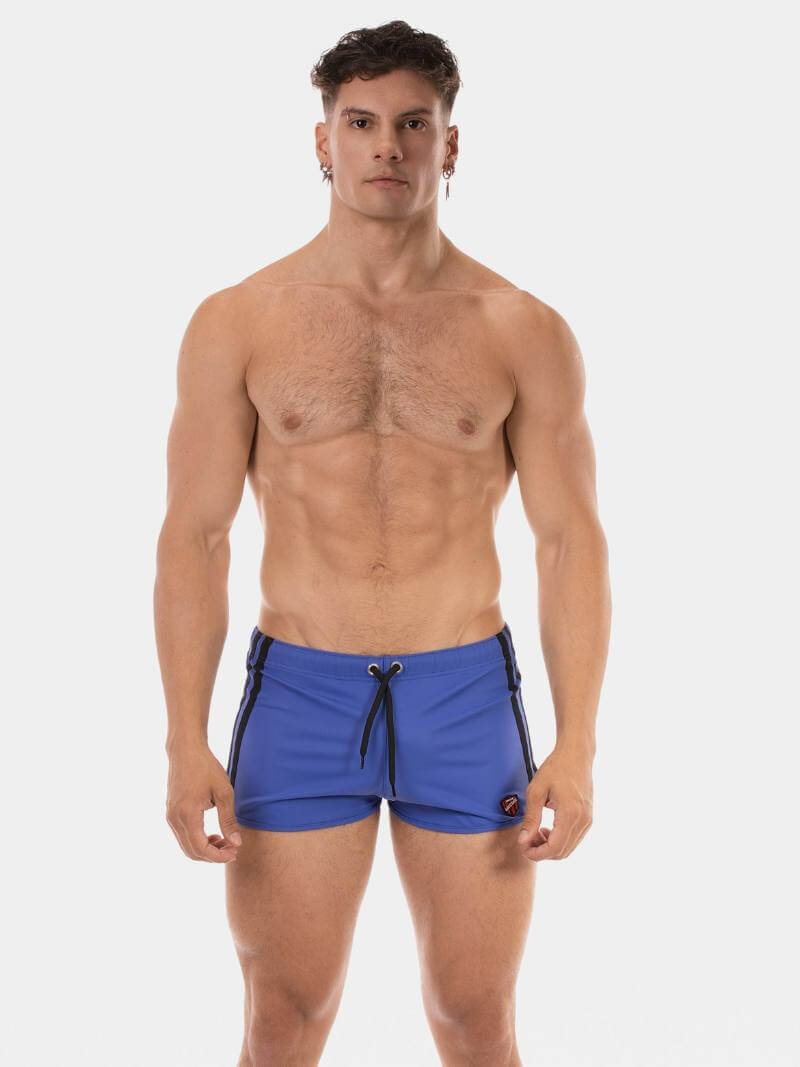 Man wearing blue swim shorts on a white background