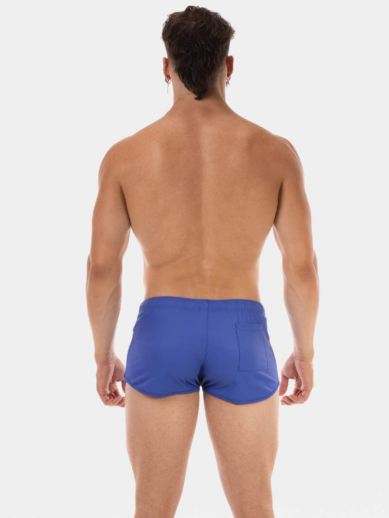 Man wearing blue swim shorts on a white background