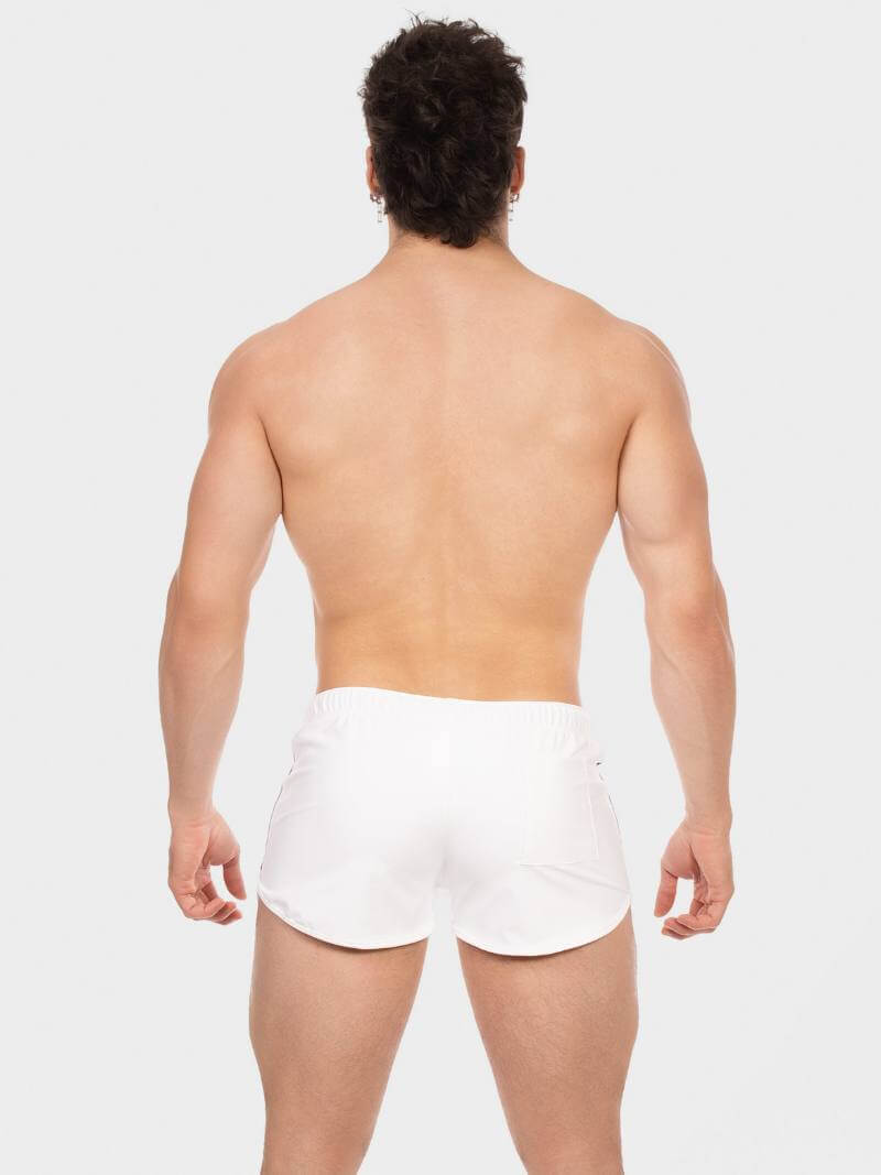 Man wearing white boxer briefs on a plain background