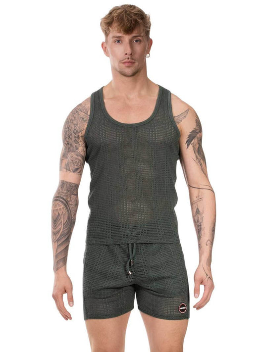 Man wearing a green checkered tank top and shorts set on a white background