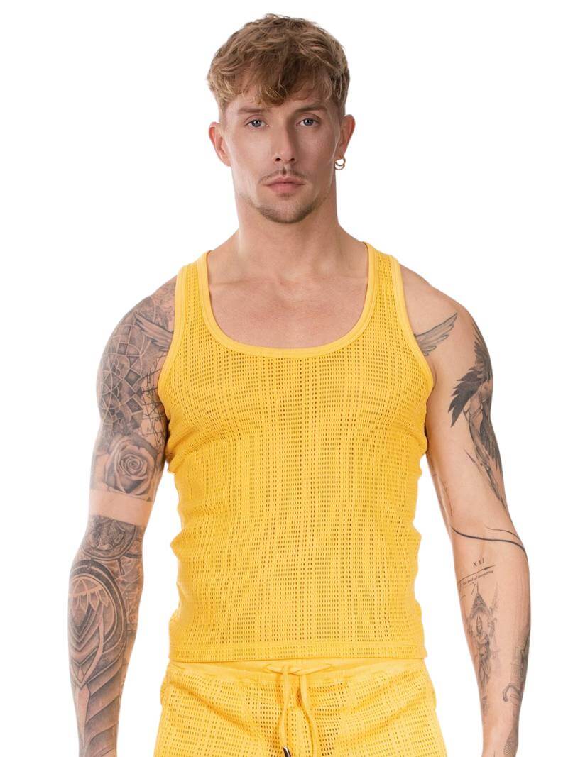 Man wearing a yellow knitted tank top and shorts on a white background
