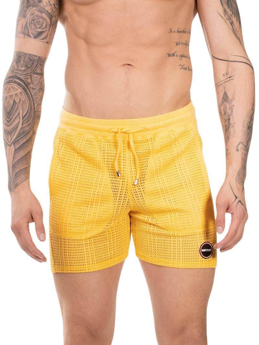 Yellow mesh swim shorts worn by a person with tattoos on a white background