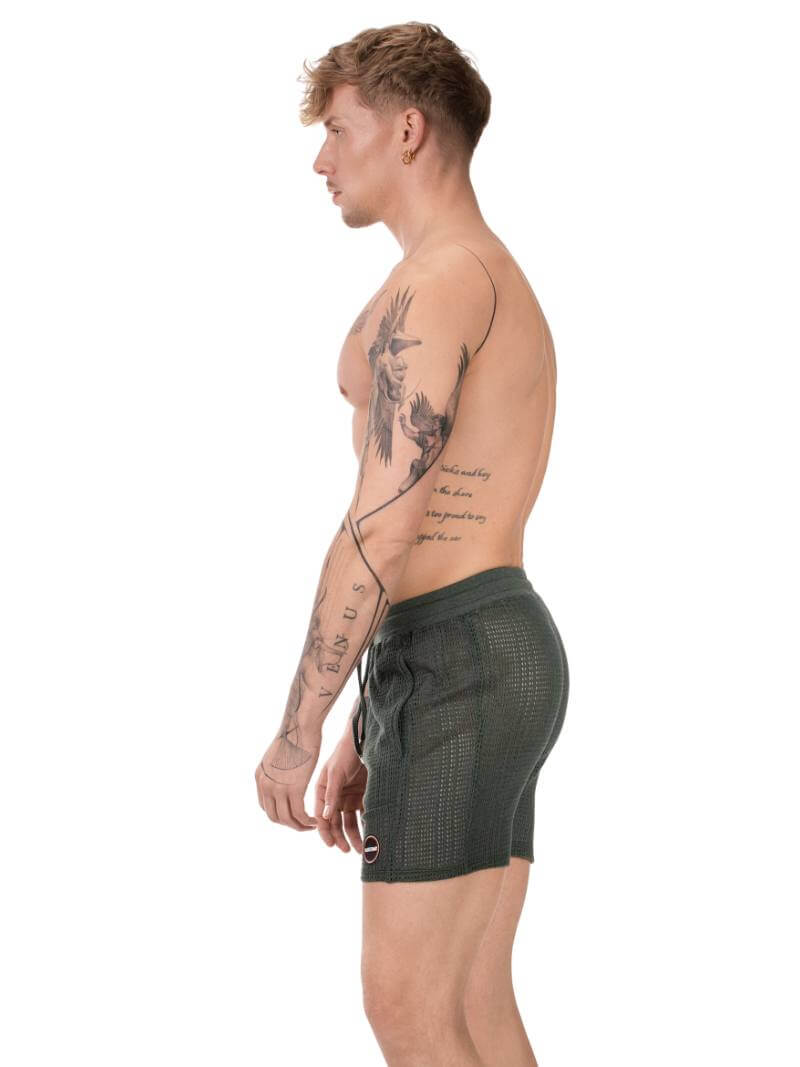 Man wearing a green athletic shorts on a white background