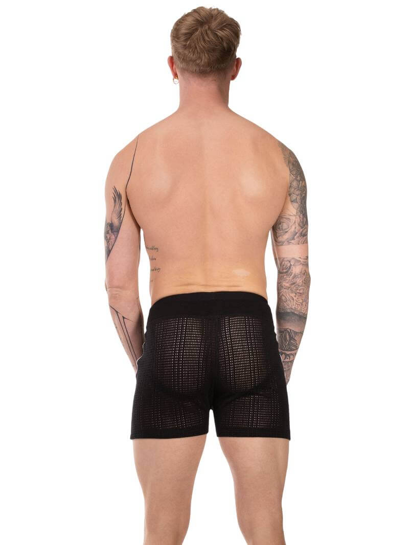 Man wearing black mesh underwear on a white background