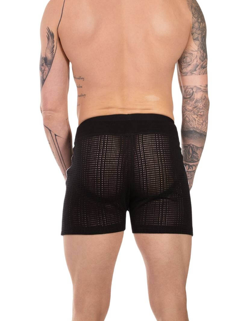 Black textured boxer briefs worn by a person with tattoos on a white background