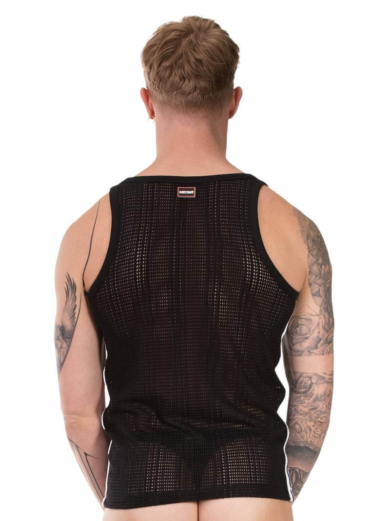 Person wearing a black sleeveless shirt with mesh design on a white background
