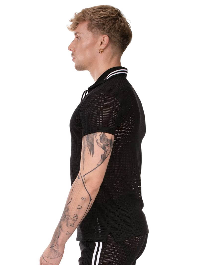 Man wearing a black mesh short-sleeve shirt with white accents on a white background