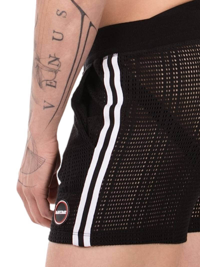 Black mesh shorts with a white stripe on a person wearing them, with visible tattoos.