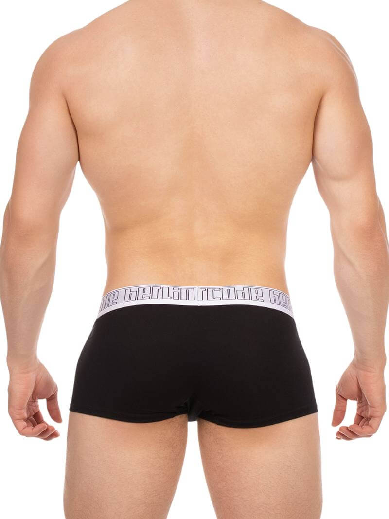 Black boxer briefs with a brand logo on the waistband, worn by a person on a white background.