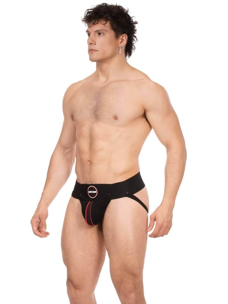Man wearing a black swim brief with red accents on a white background