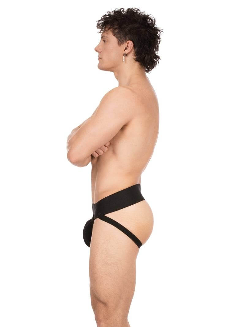 Person wearing a black thong against a white background