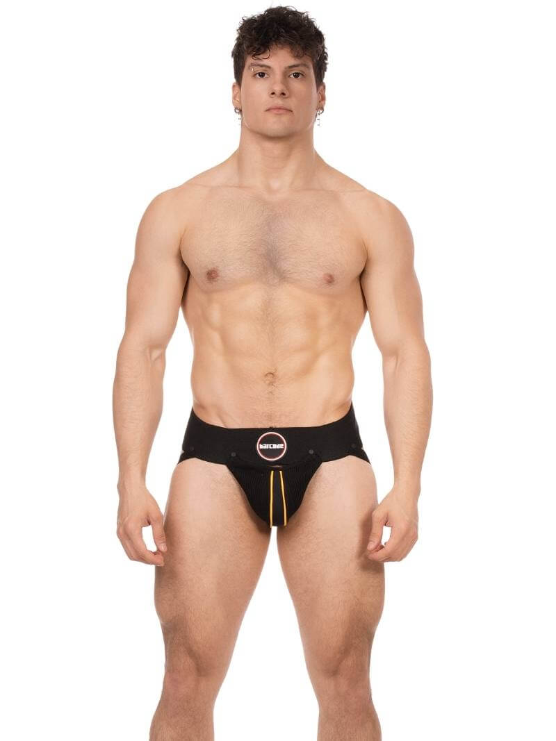 Man wearing a black Speedo swim brief on a white background