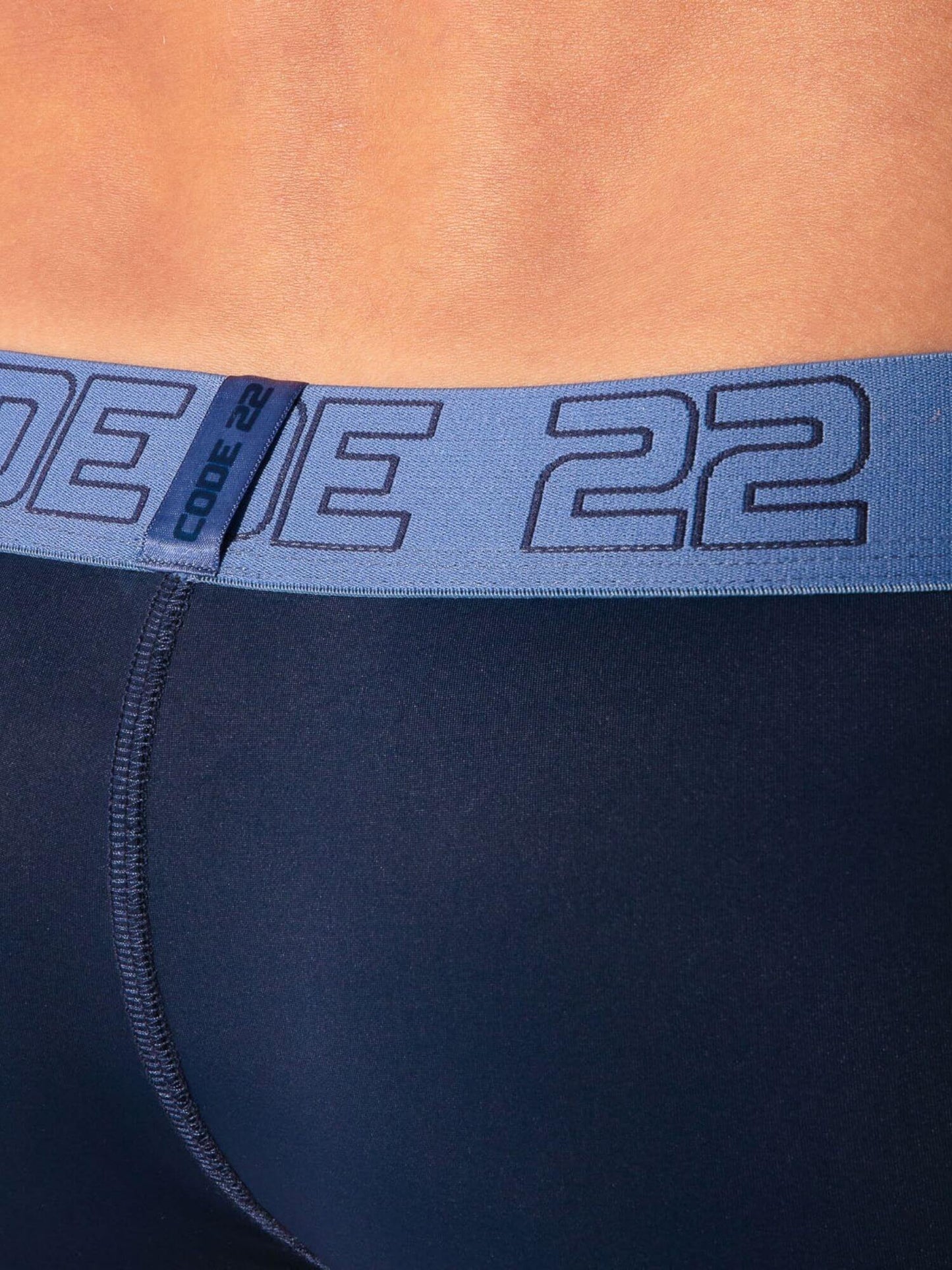 navy athletic shorts with a blue waistband displaying 'CODE 22' branding.