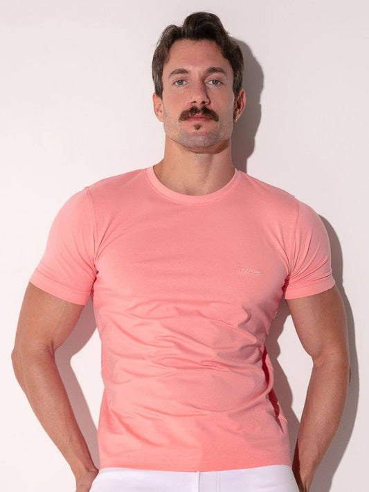 Man wearing a pink t-shirt against a white background
