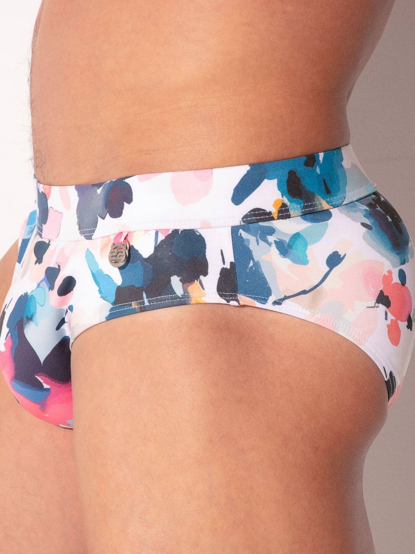 Colorful floral-patterned swimwear on a neutral background