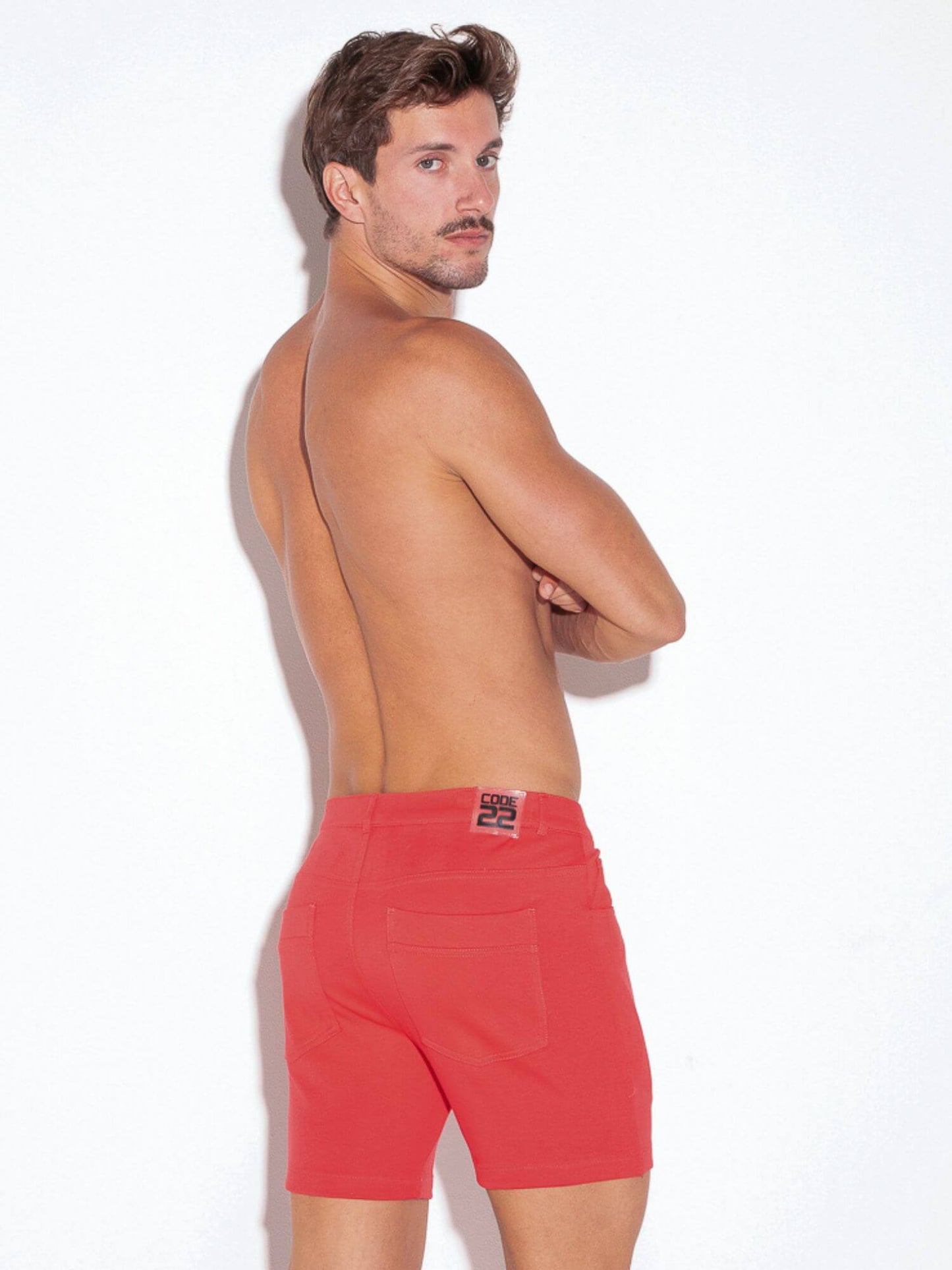 Man wearing red cotton shorts on a white background