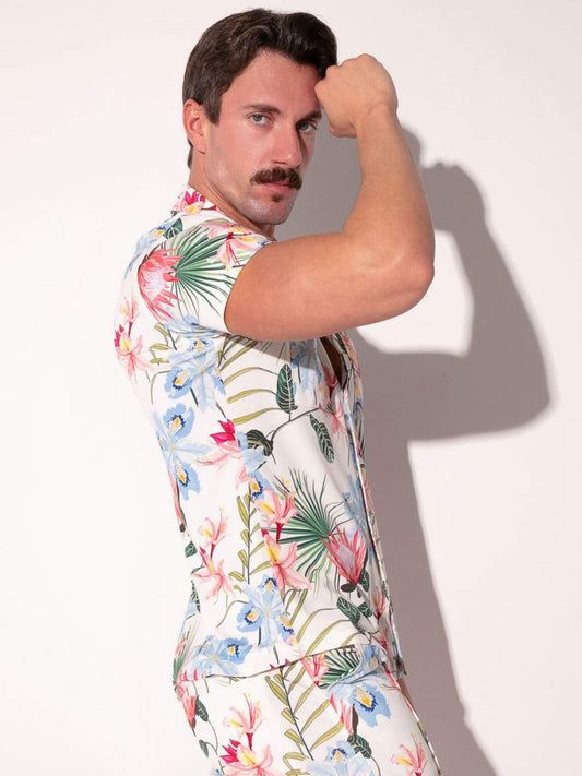 Man wearing a colorful floral shirt against a white background