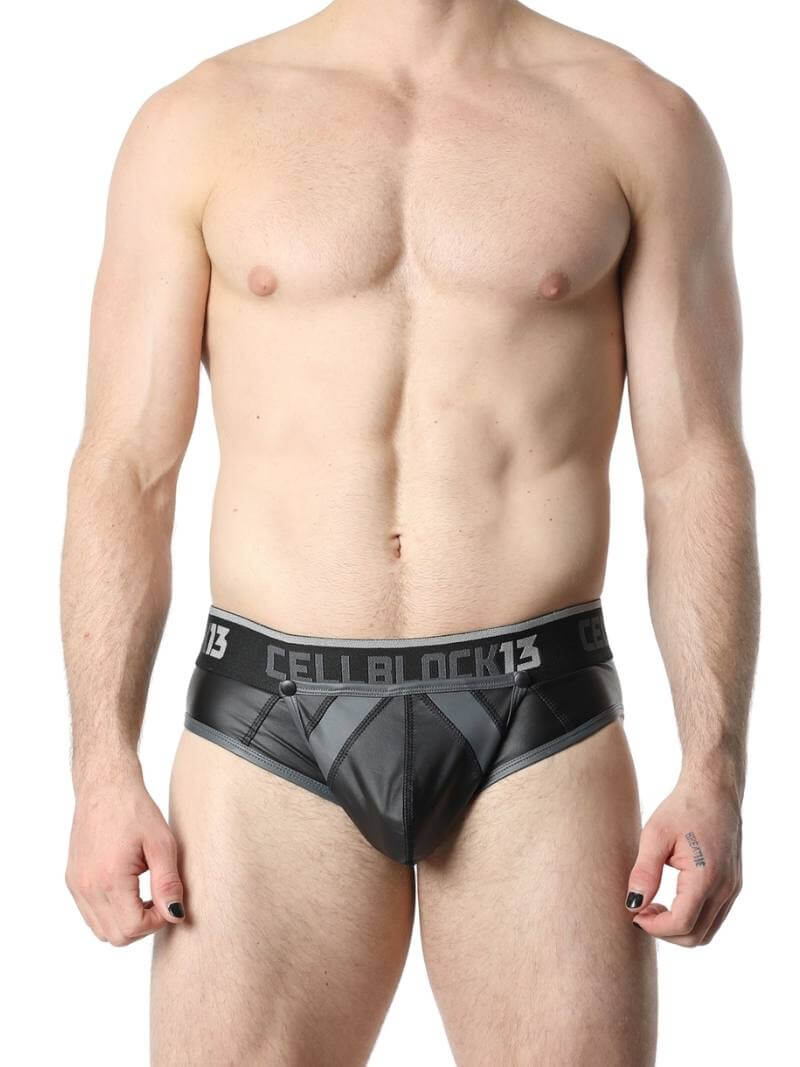This image features the CellBlock13 Anti-Chrome Vegan Leather Jock Brief, designed with a sleek and matte black finish. The jock brief has contrasting trims that add a touch of color and style, and it features a bold "CELBBLOCK13" branding on the waistband.