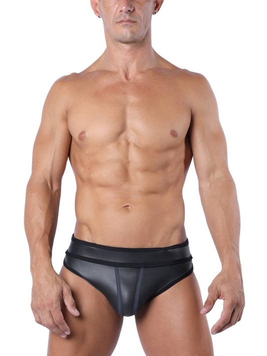 A model wearing a black neoprene jock brief with colored and striped piping, and matching colored jock straps. The waistband features a jacquard logo with 'CellBlock13' branding.