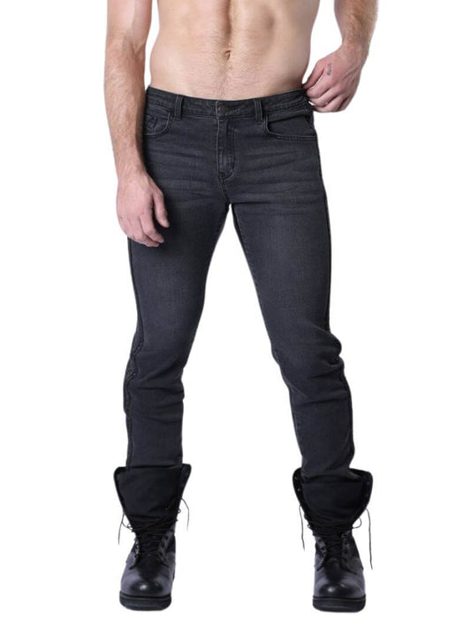 A pair of blue denim jeans with black vegan leather panels on the saddle and legs, featuring a mid-rise waist, zip-up fly, button fastening, belt loops, and five pockets. The person is wearing black boots.