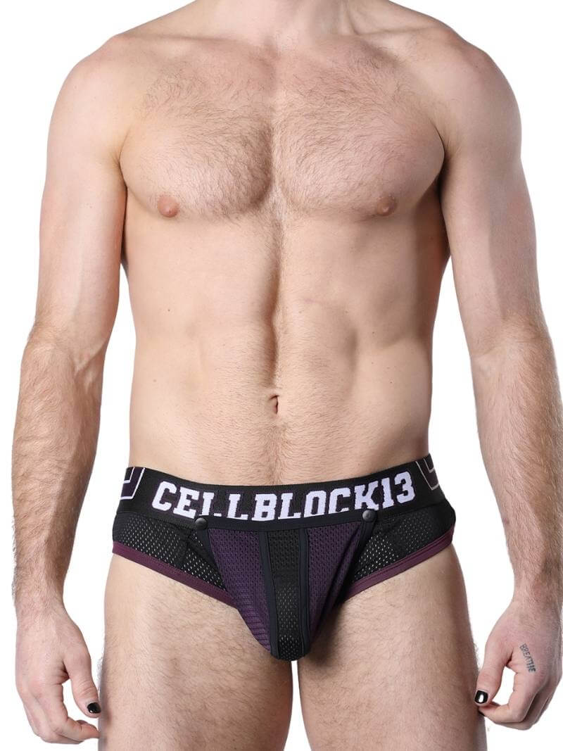 This image features the CellBlock13 Take Down Mesh Brief, showcasing its sporty and cheeky design. The brief is black with green mesh accents and includes a rear zip and a removable pouch for added convenience and ventilation.