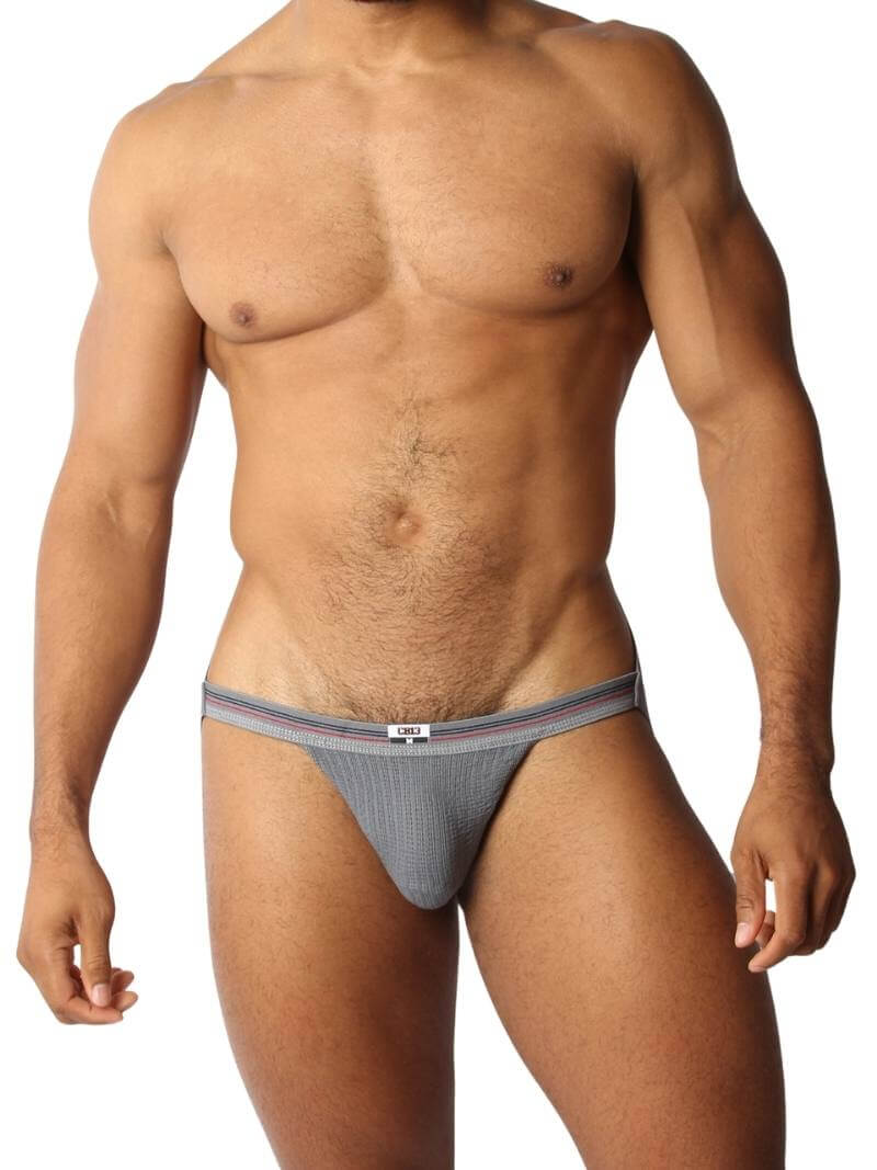 A red CellBlock13 slim waist jockstrap with a striped waistband and the brand label visible.