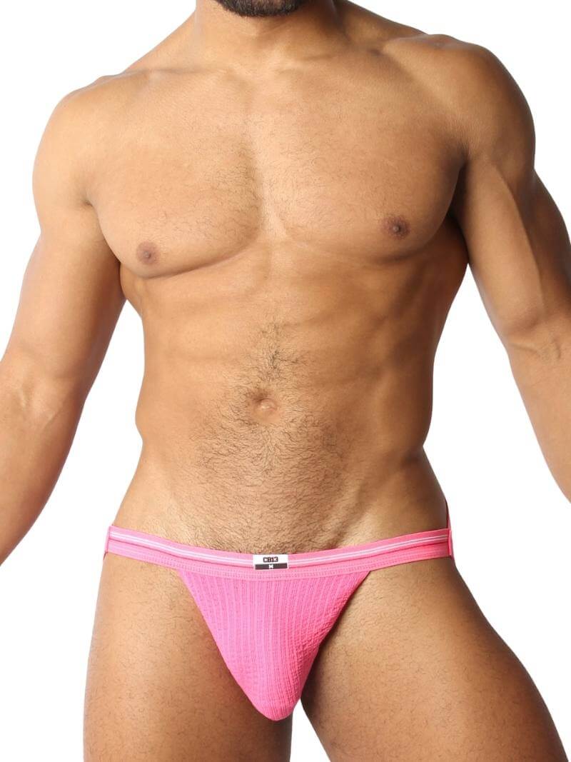A red CellBlock13 slim waist jockstrap with a striped waistband and the brand label visible.