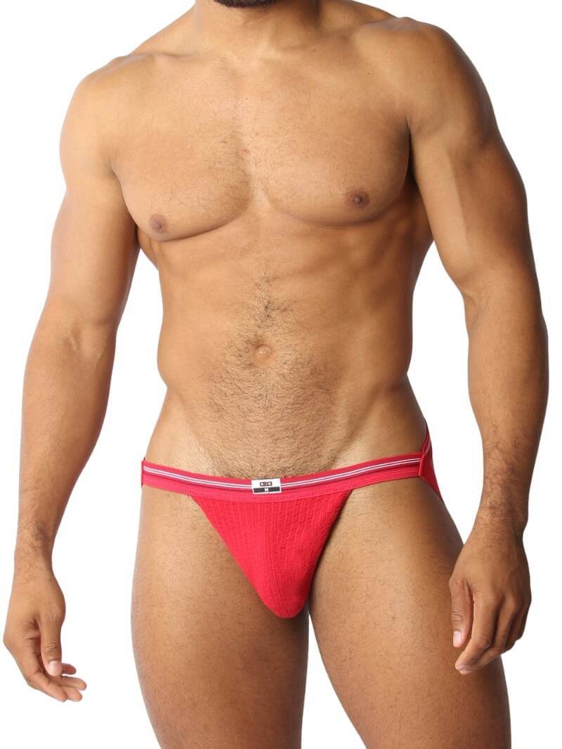 A red CellBlock13 slim waist jockstrap with a striped waistband and the brand label visible.