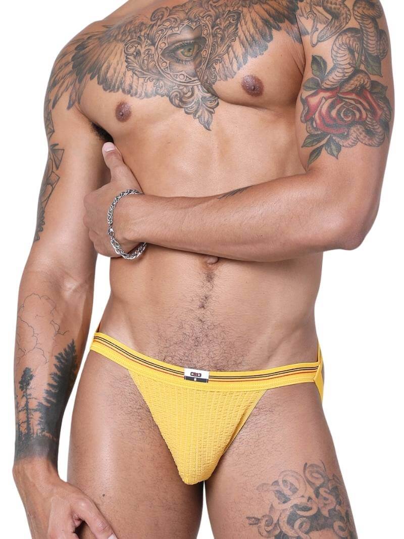 A red CellBlock13 slim waist jockstrap with a striped waistband and the brand label visible.