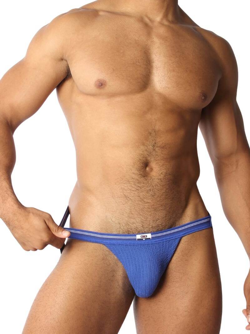 A blue CellBlock13 slim waist jockstrap with a striped waistband and the brand label visible.
