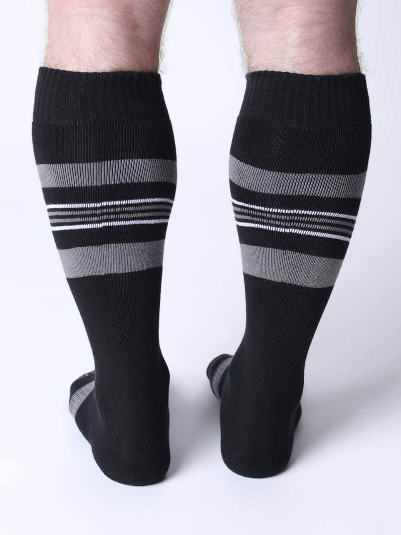 Black knee-high socks with gray and white stripes on a white background