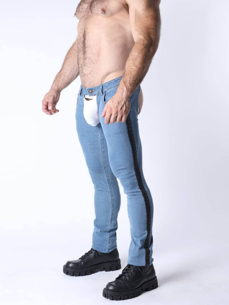 Man wearing light blue jeans with a black stripe and black boots on a white background