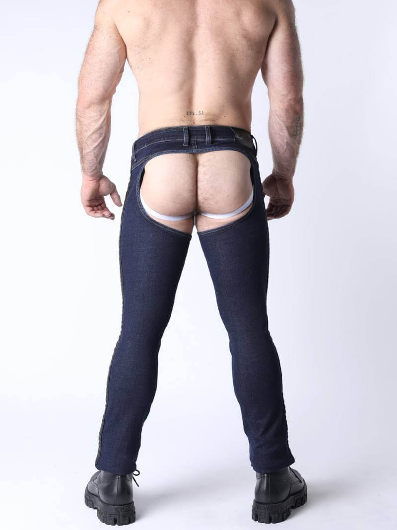 Person wearing dark blue jeans with a white background