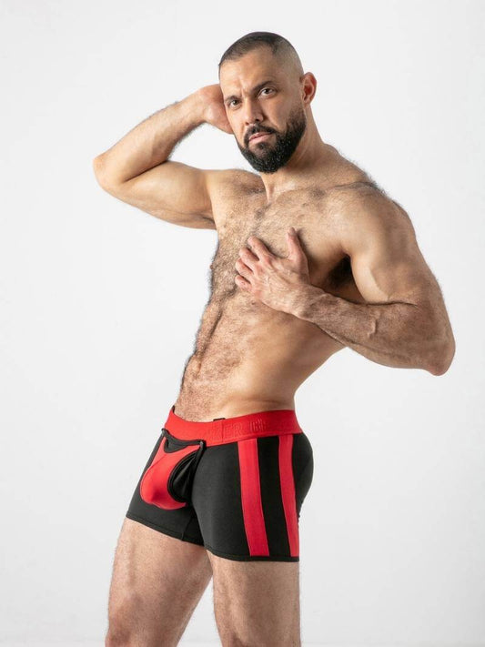 Man wearing black and red boxer briefs on a white background