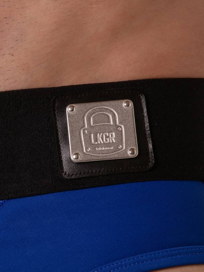 Close-up of a black belt with a metallic label featuring 'LKGR' on a blue garment.