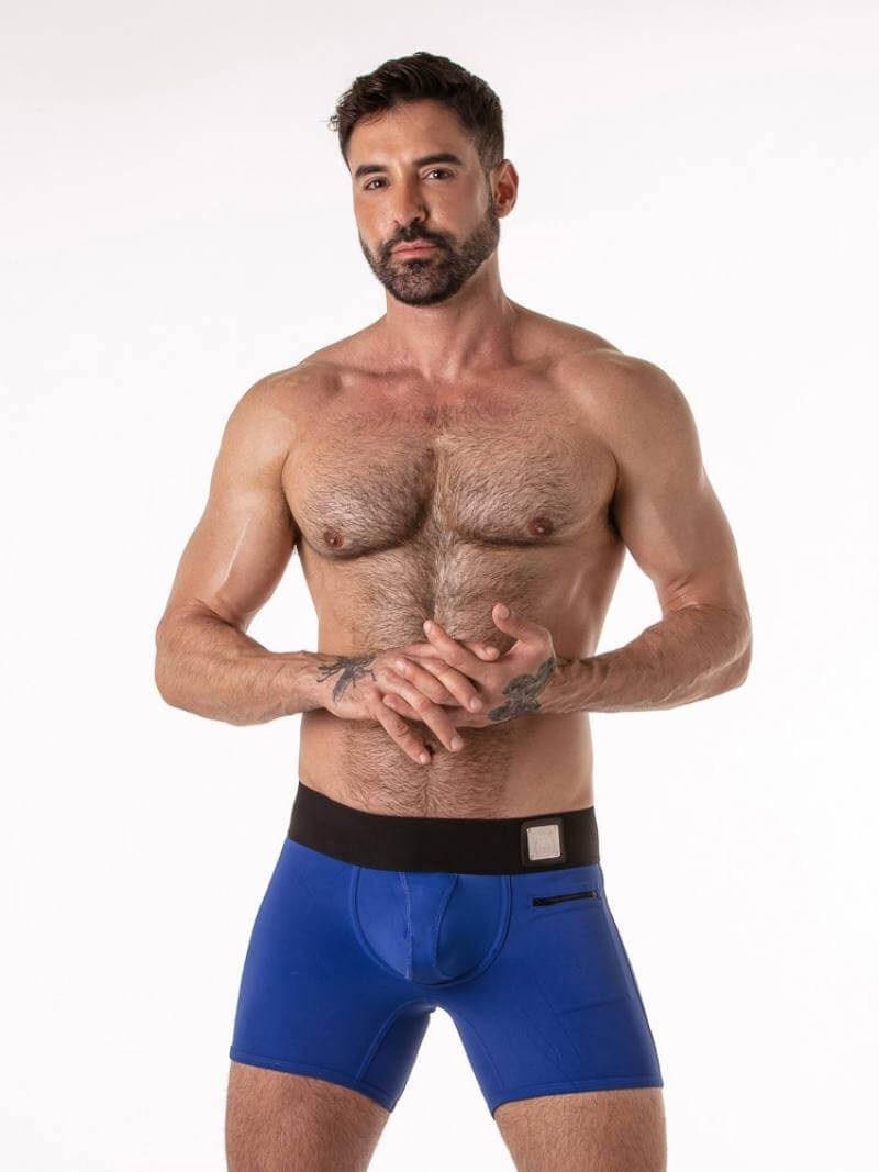 Man wearing blue boxer briefs on a white background