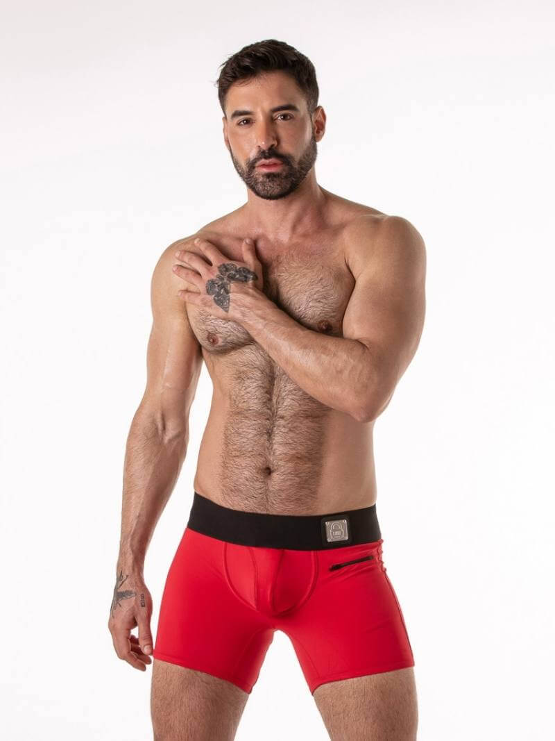 Man wearing red underwear with a black waistband on a white background