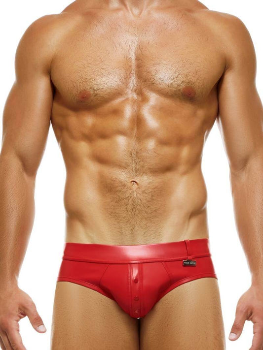 A man wearing a red leather-look brief with a low-rise waist and metallic Modus Vivendi logo.