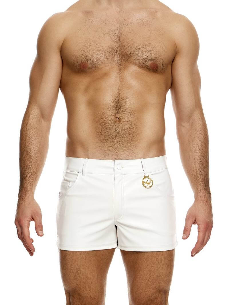 A man wearing black leather-look 5 pocket shorts with a metallic MV logo.