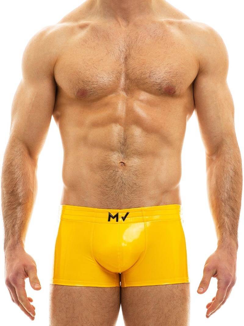 This image displays the MODUS VIVENDI PVC Vinyl Boxer Trunk, worn by a fit male model. The boxer trunk features a high shine, glossy PVC material, reminiscent of latex but made from 100% polyurethane for durability and a super shiny appearance.