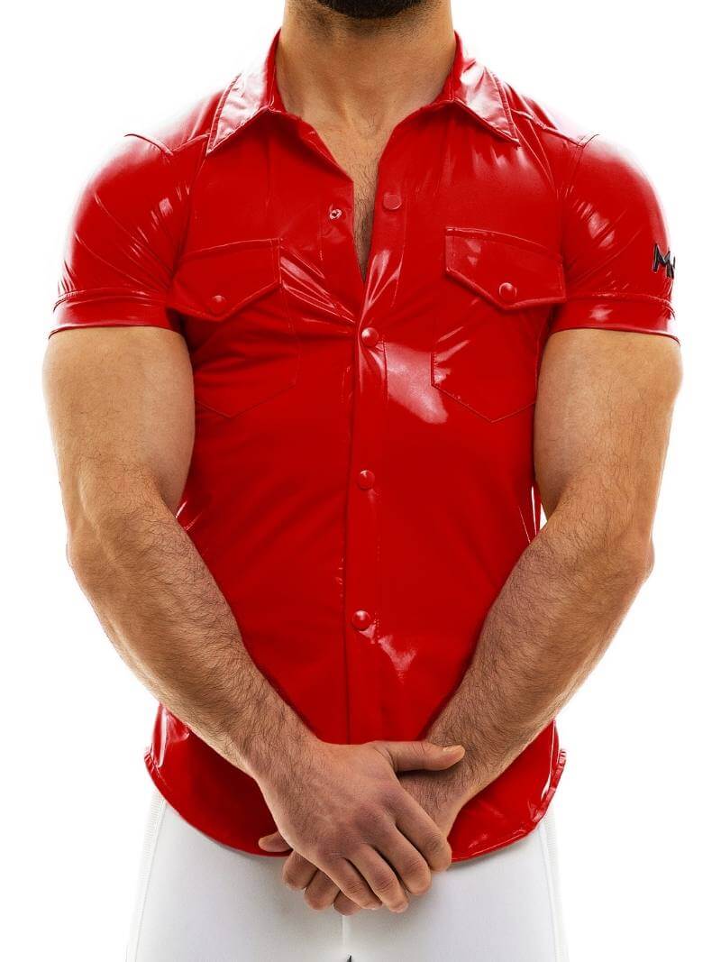 A person wearing a shiny black PVC look shirt with short sleeves, a collar, and front buttons. The shirt has two front buttoned pockets and features an MV logo on the sleeves.