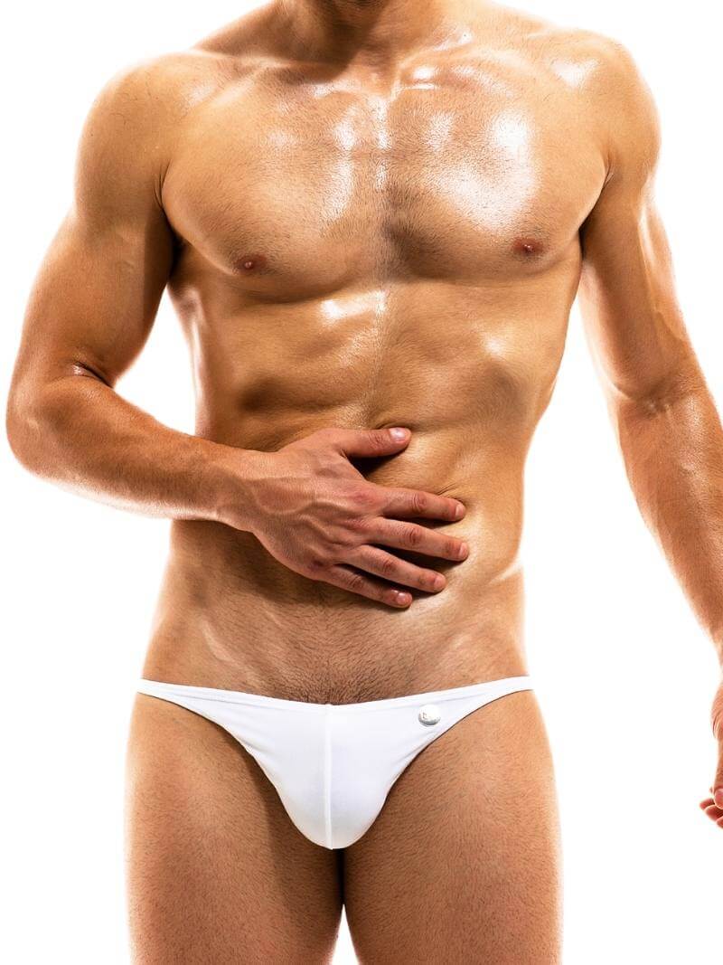 A man wearing a red MODUS VIVENDI Luxe swimming bikini brief with a low waist and high-cut legs.
