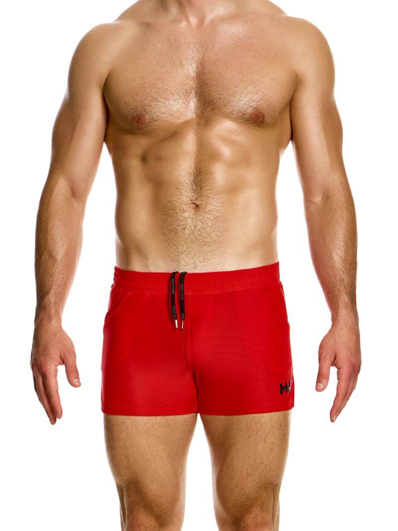 A pair of red active shorts with a drawstring waistband, elasticated at the waist, and featuring side slits. The brand's logo is visible on the leg.