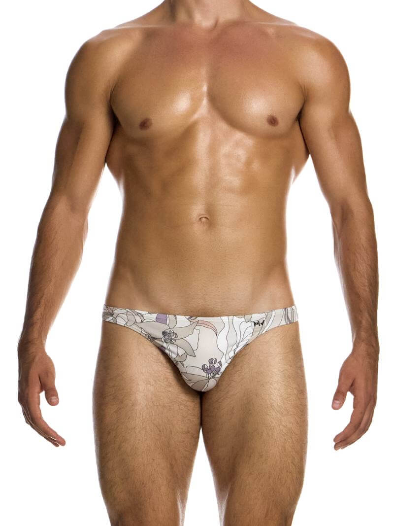 This image features the MODUS VIVENDI Art Nouveau Floral Low Cut Swim Bikini, modeled in a striking art nouveau floral design with pastel mint colors. The swimwear briefs are crafted to be super-low-rise with high-cut legs, offering a flattering fit that enhances the silhouette with timeless elegance.
