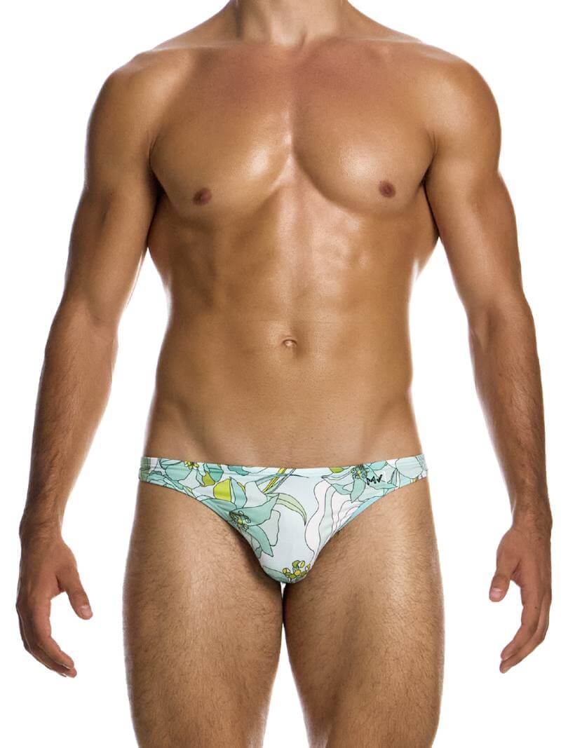 This image features the MODUS VIVENDI Art Nouveau Floral Low Cut Swim Bikini, modeled in a striking art nouveau floral design with pastel mint colors. The swimwear briefs are crafted to be super-low-rise with high-cut legs, offering a flattering fit that enhances the silhouette with timeless elegance.