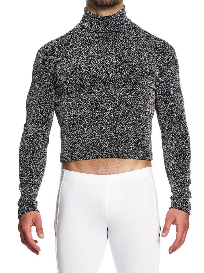 A male model wearing a long-sleeved, cropped, silver metallic roll neck sweatshirt with a glittery label.