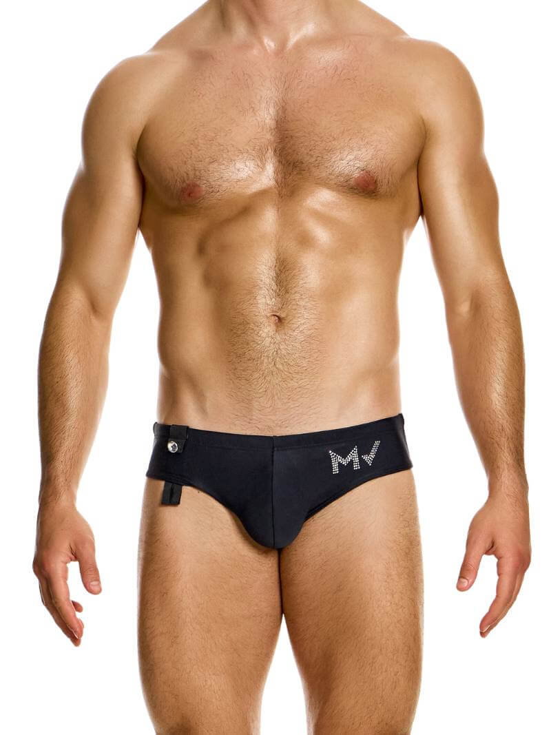A model wearing white Modus Vivendi Diamonds swim brief with crystal stone branding and adjustable drawstrings.